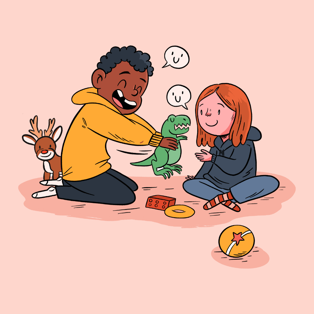 Bildet viser to barn som leker sammen. Den ene holder en grønn dinosaur, og begge ser glade ut. Rundt dem er det flere leker, inkludert en ball og en kloss. Bak barna står et reinsdyr med en rød nese. De har en vennlig og positiv atmosfære. «KI-generert bildetekst, kvalitetssikret før publisering.»